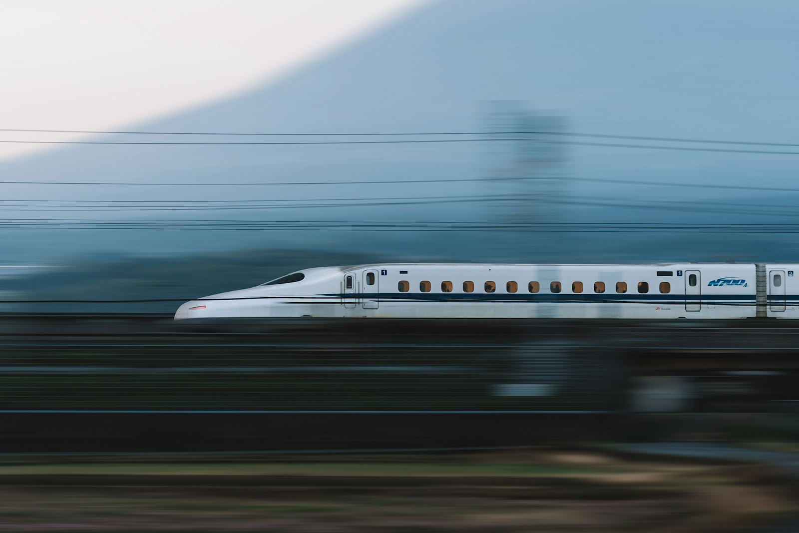 Shinkansen bullet train passing Mount Fuji